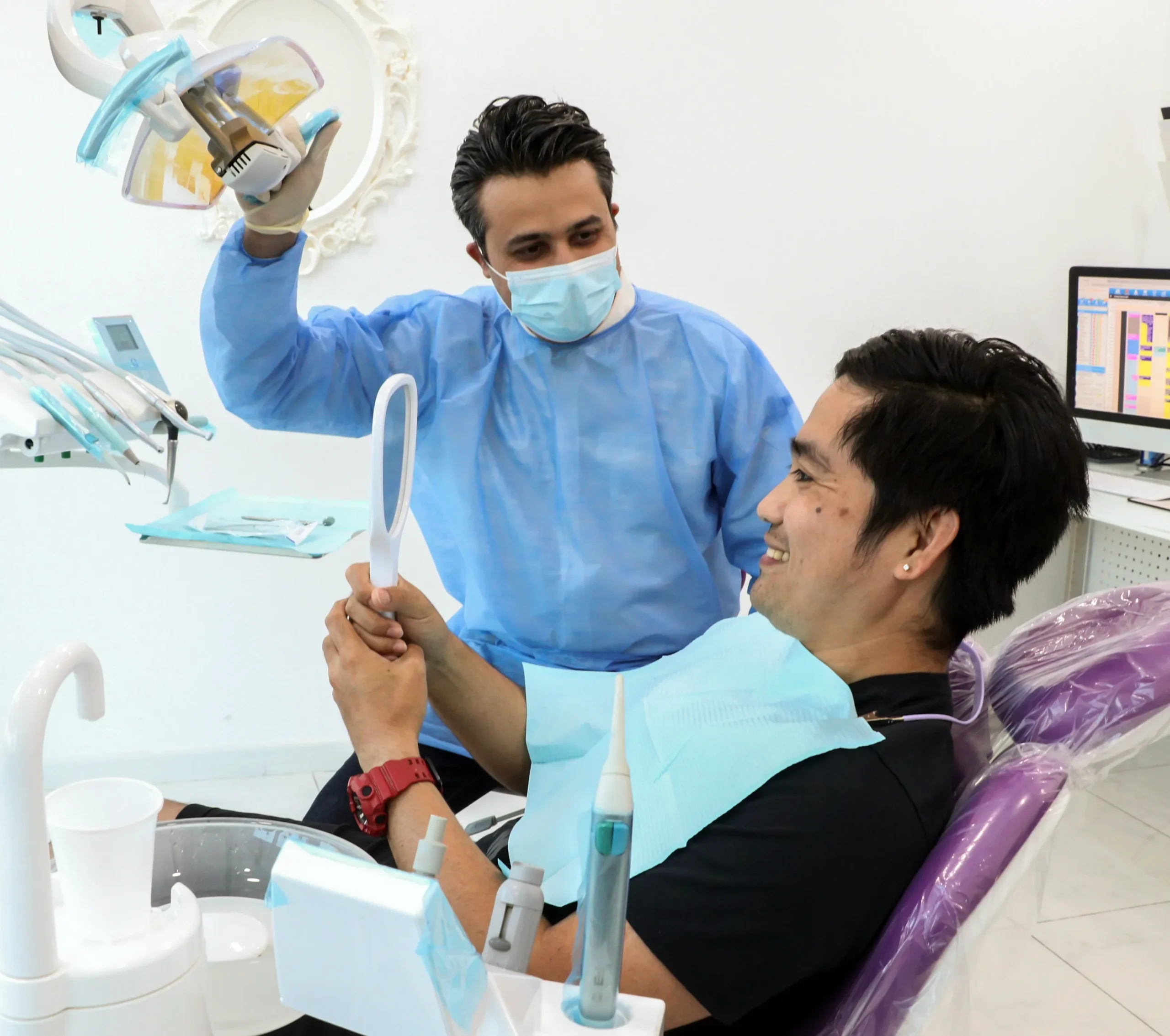 Dentist performing a cosmetic dental procedure on a patient in Dubai