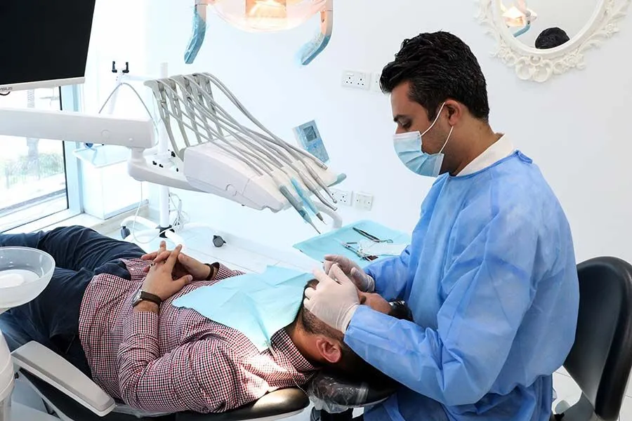 Dental professionals working on repairing and restoring a patient's smile with modern dental equipment.