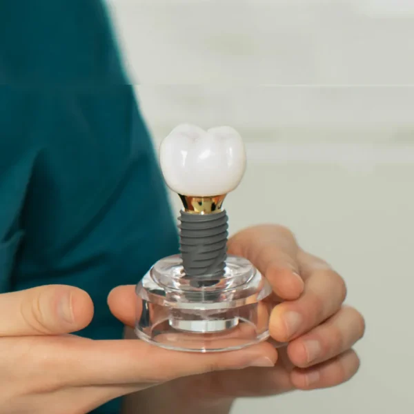 A set of healthy teeth with a dental implant highlighting its long-term durability